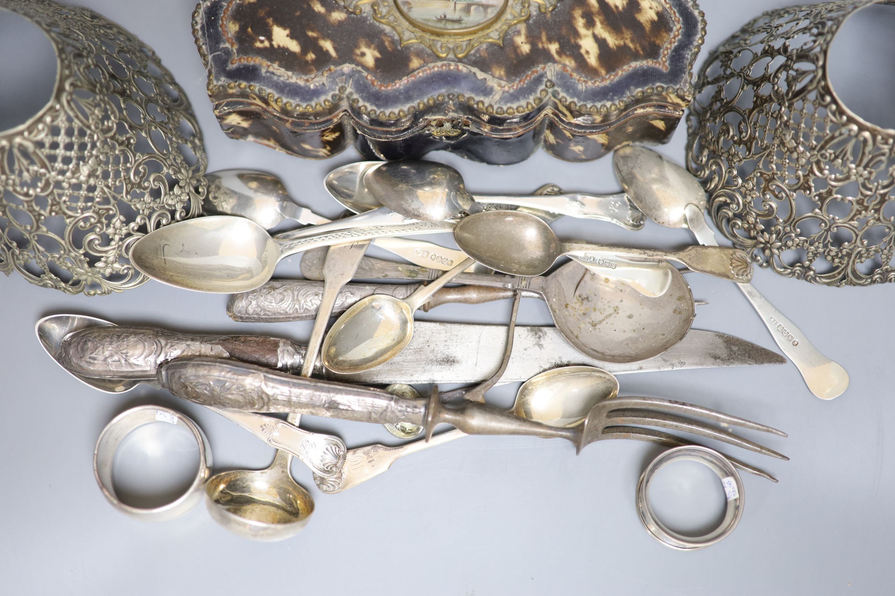 A group of assorted silver flatware and other items, including teaspoons, napkin ring, pierced Gorham lamp shades, carving implements and a Palais Royale faux tortoiseshell casket